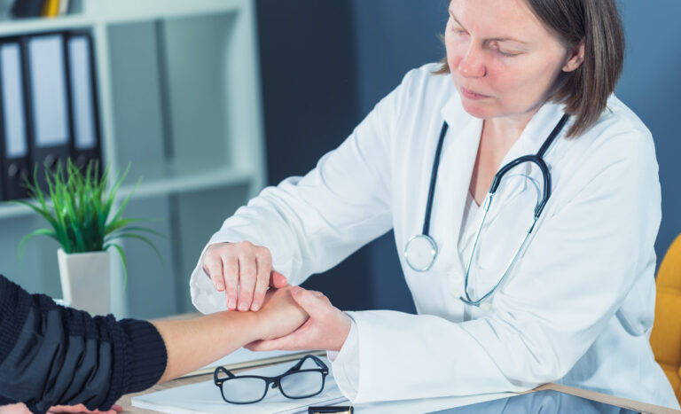 Female patient at orthopedic doctor medical exam for wrist injur